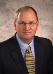 Professional man in suit and tie with glasses.